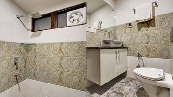A bathroom with a shower, sink, and toilet.