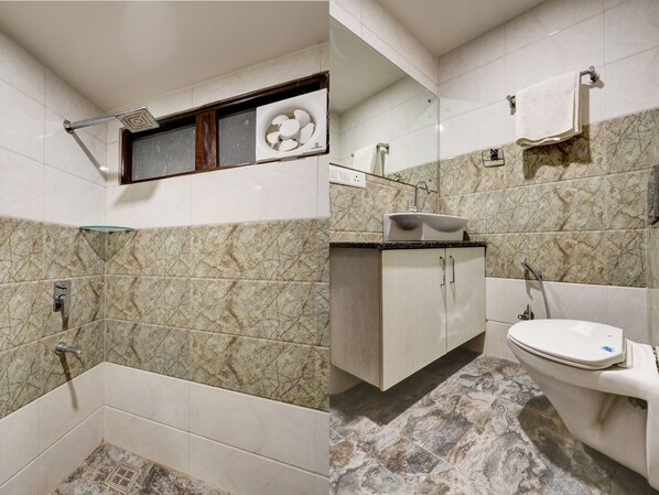 A bathroom with a shower, sink, and toilet.