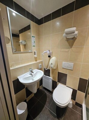Shower, hair dryer, towels, toilet paper