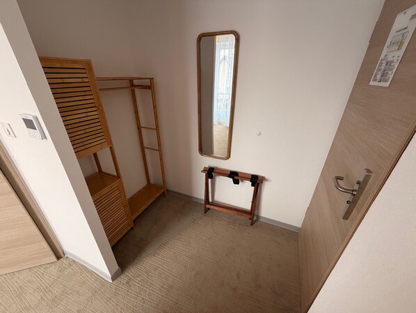 A small, compact room with a bunk bed, a mirror, and a small table. - Hotel du Village (Village-Neuf)