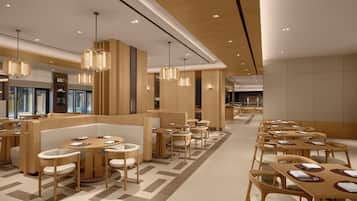 Un restaurante moderno con mobiliario de madera, iluminación colgante y un patrón geométrico en el suelo.
