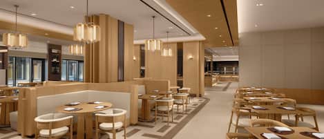 A modern restaurant with wooden furniture, pendant lighting, and a geometric floor pattern.