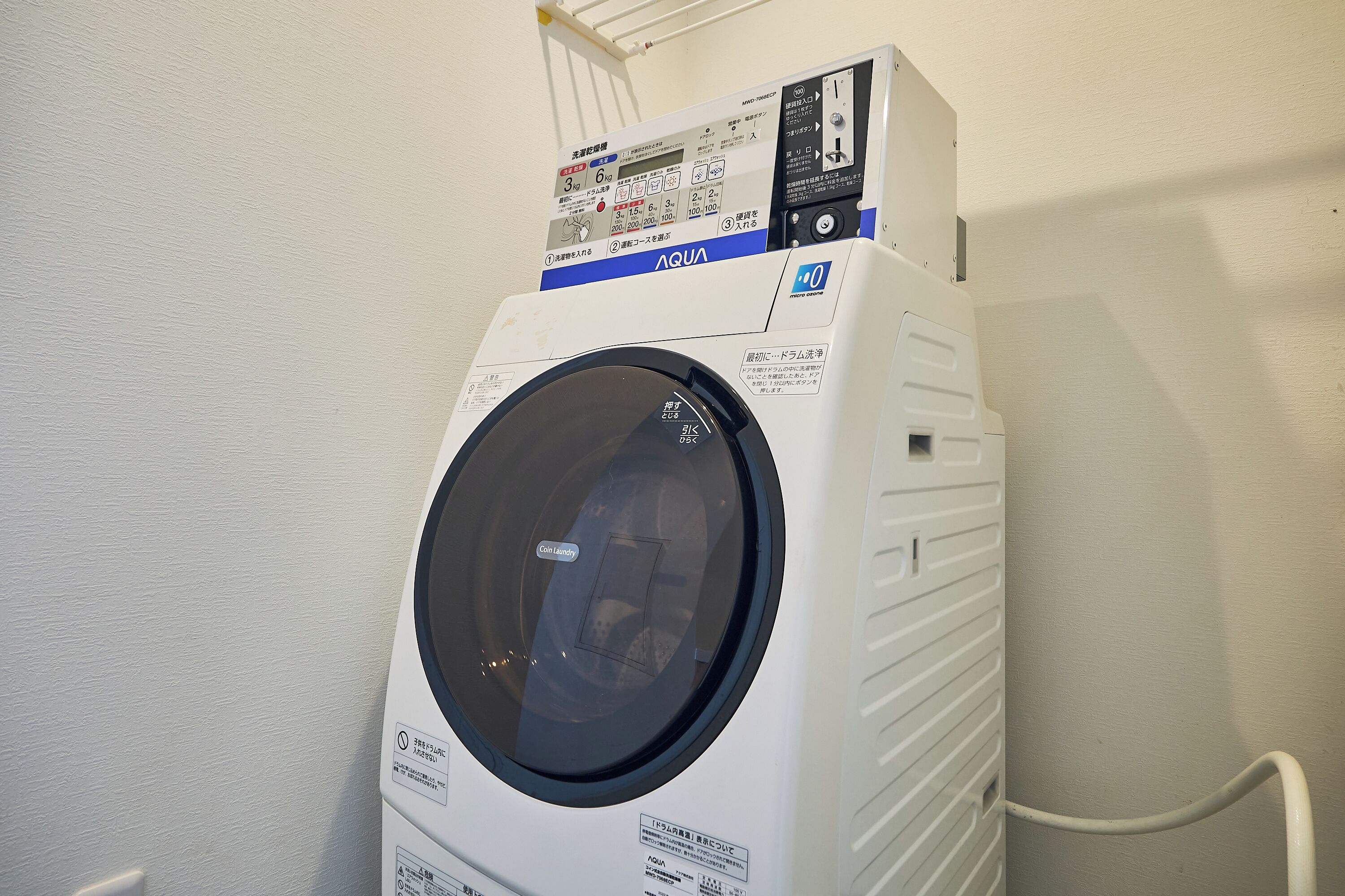 A front-loading white washing machine with a control panel and a circular door.