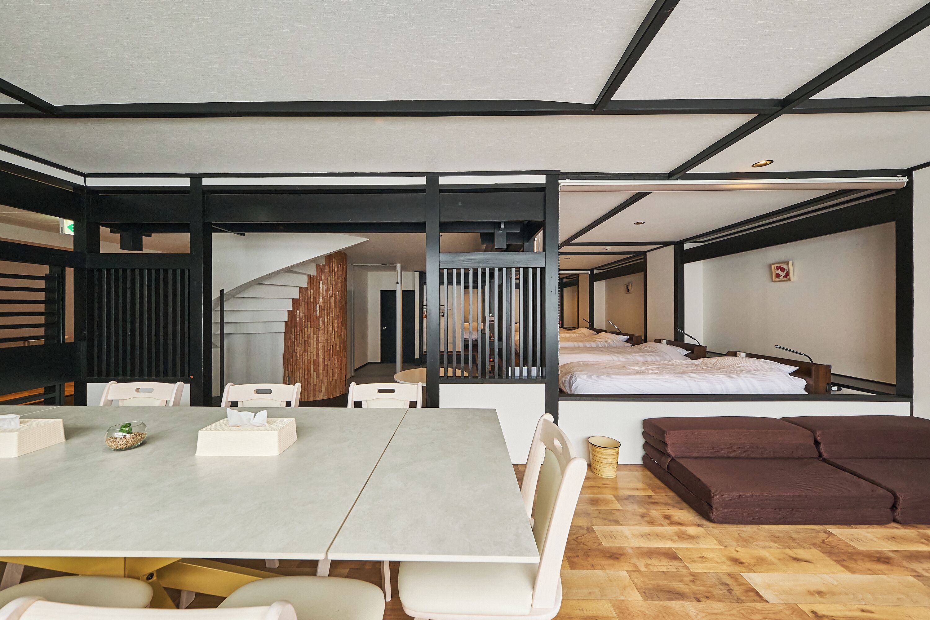 Habitació d'hotel moderna amb zona de dinar, escala i llit.