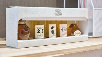 A display of four bottles of whisky on a shelf.