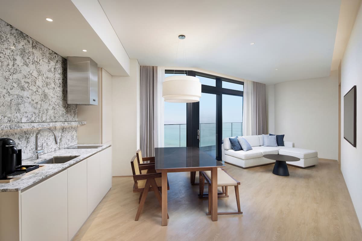 A modern apartment with a kitchen, dining area, and living room.
