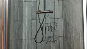 A shower with a handheld showerhead, a wall-mounted faucet, and a rain shower head. - Emily in Paris - Panthéon - Luxembourg - Studio (Paris)