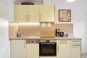 Réfrigérateur, un four, surface de cuisson, lave-vaisselle