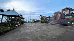 A building with a traditional architectural style, featuring a prominent entrance with steps leading up to a covered area. - Munduk Luwih Ecolodge Bedugul by AGATA (Baturiti)