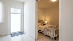 A room with a bed, a bedside table, and a lamp. - New 1Bedroom Apt. In Condado! C.4 (San Juan)