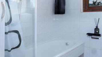 Combined shower/bathtub, deep-soaking bathtub, hair dryer, towels