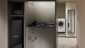 A compact kitchenette with a microwave, coffee maker, and sink. - Minn Nihonbashi Suitengumae (Tokyo)