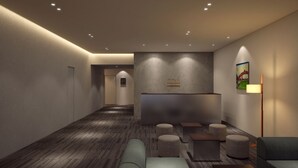 A modern reception area with a reception desk, seating area, and a hallway leading to an elevator. - Minn Nihonbashi Suitengumae (Tokyo)