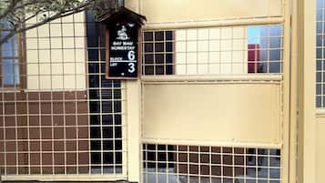 A building with a sign indicating 'Bay Mau Homestay Block 6 Lot 3.'
