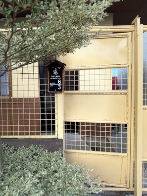 A building with a sign indicating 'Bay Mau Homestay Block 6 Lot 3.'