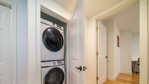 A laundry room with two stacked front-loading washing machines. - Cornhill1BED,Cozy,WiFi_EquipKitchen_TV+HighFalls (Rochester)