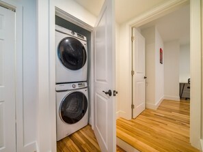 A laundry room with two stacked front-loading washing machines.