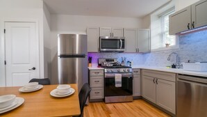 A compact kitchen with a refrigerator, microwave, stove, and sink. - Cornhill 2BDRM-HighFall+EquippedKitchen+Wi-Fi (Rochester)