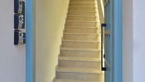 A staircase leading to an apartment with the number 10-12. - Amara Porto Living | Apartment 2 (Chania)