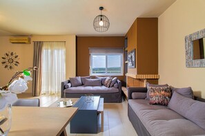 Classic Villa, 2 Bedrooms, Sea View | Living area | 50-inch Smart TV with satellite channels - Theo Villas With Sea View (Marathokefala)
