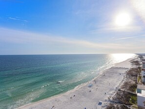 A beach with a clear sky, calm sea, and a few people walking. - The Adventurer’s Micro Studio at Beachview (Fort Walton Beach)