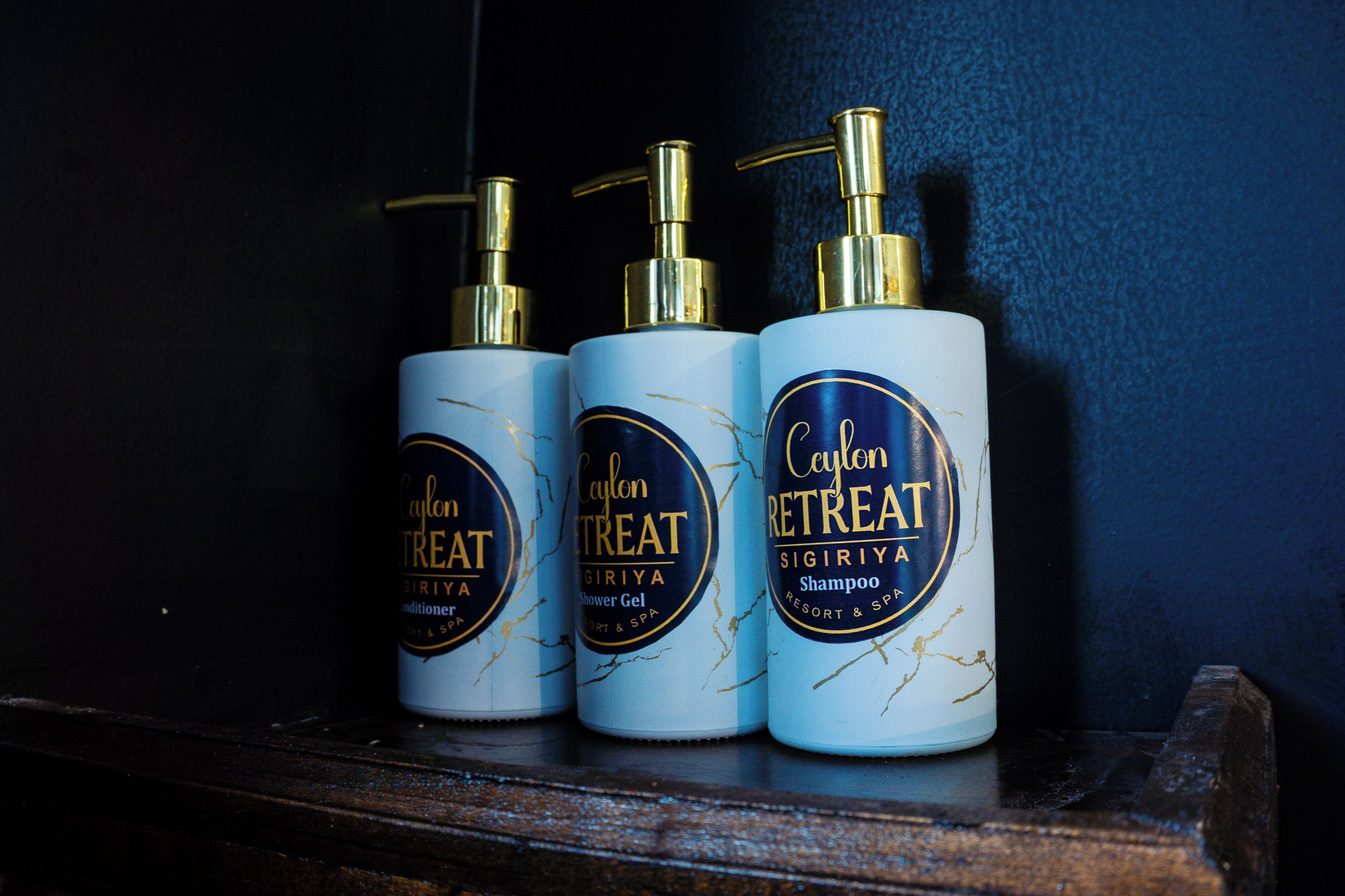 Three bottles of Caylon Retreat shampoo on a shelf.