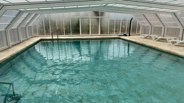 A swimming pool with a glass ceiling, clear water, and a tiled deck. - PEDRO MARIN, 5 Bedroom House in Complejo Rural Orgiva (Orgiva)