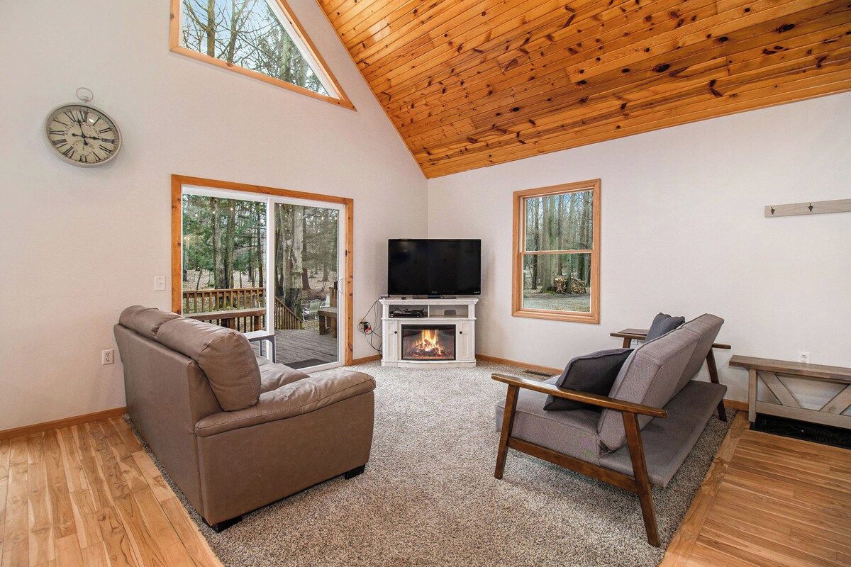 A living room with a fireplace, a television, and a sofa.
