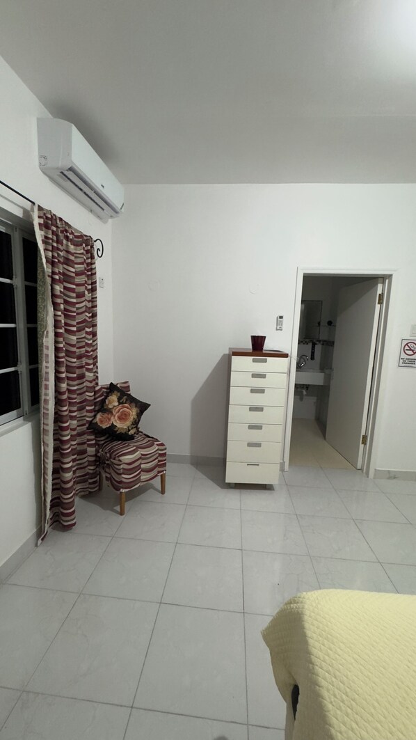 A room with a bed, a wardrobe, a window with curtains, and an air conditioning unit. - Choose Your Stay: Private Guest Rooms, Bathroom, or a Furnished Apartment (Clarendon Park)