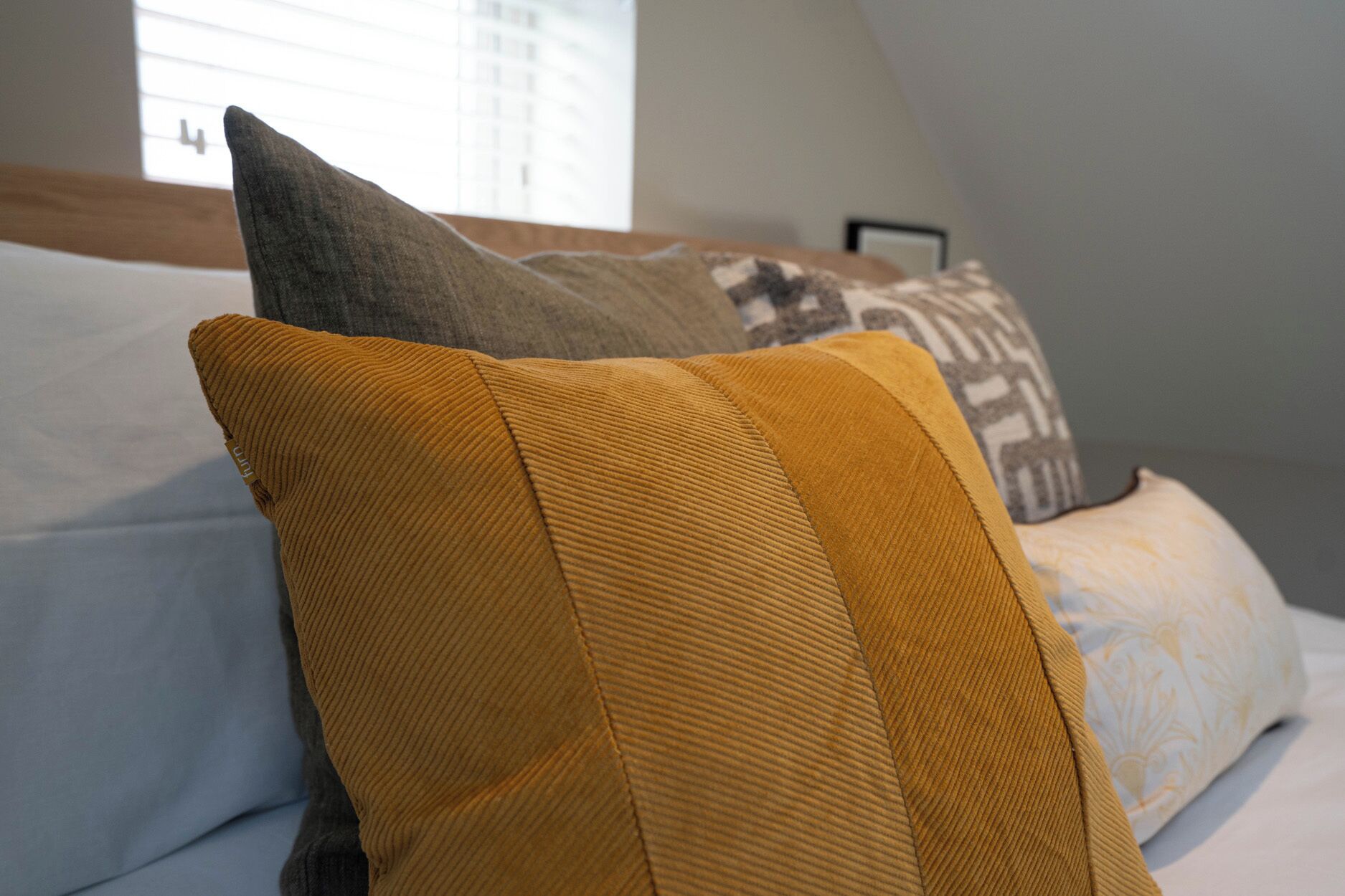 A bed with a headboard and pillows.