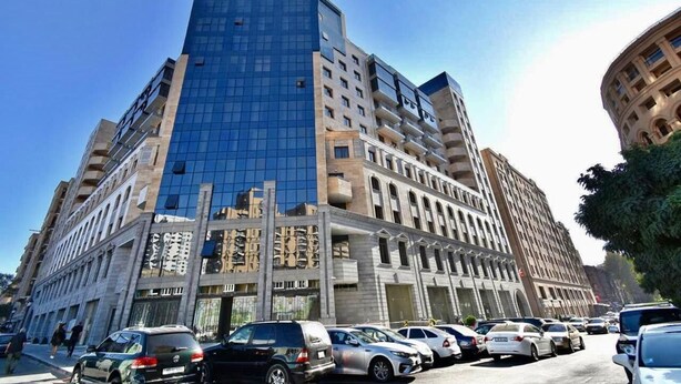 A multi-story building with a modern glass facade and a mix of architectural styles.