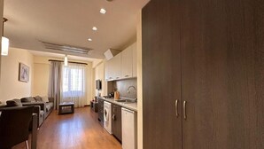 A modern kitchen with wooden cabinets, a built-in oven, and a sink.