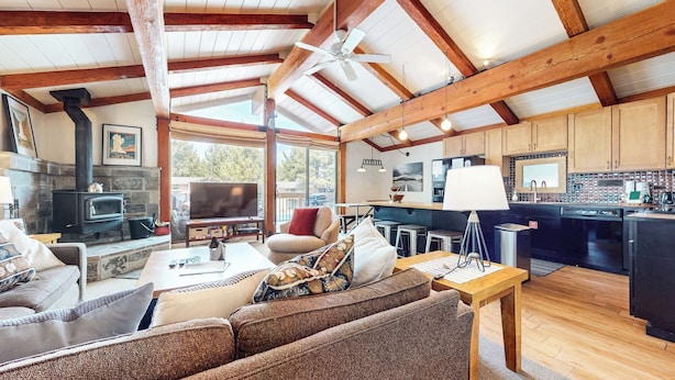 A cozy living room with a fireplace, a television, and comfortable seating.