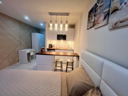 At Isla Verde. 1: minute walking to the beach and 5: minutes driving to airport