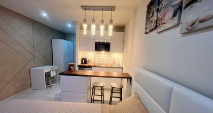 At Isla Verde. 1: minute walking to the beach and 5: minutes driving to airport