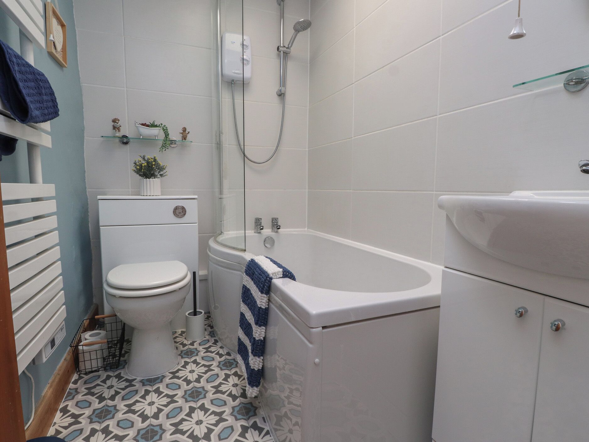 A bathroom with a toilet, a bathtub, and a sink.