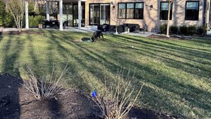 A two-story building with a modern design, featuring large windows and a covered patio area. - New construction, 4-bedroom house with, fitness room in lovely Bridgehampton (Bridgehampton)