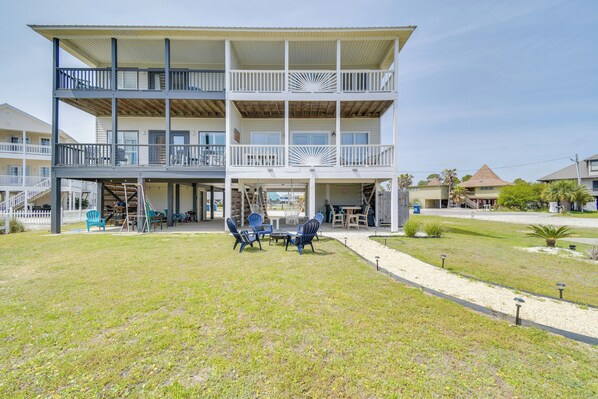 A multi-story building with a covered outdoor area, a pool, and a lawn. - 2 Blocks to Beach: Gulf Shores Getaway w/ Dock! (Gulf Shores)