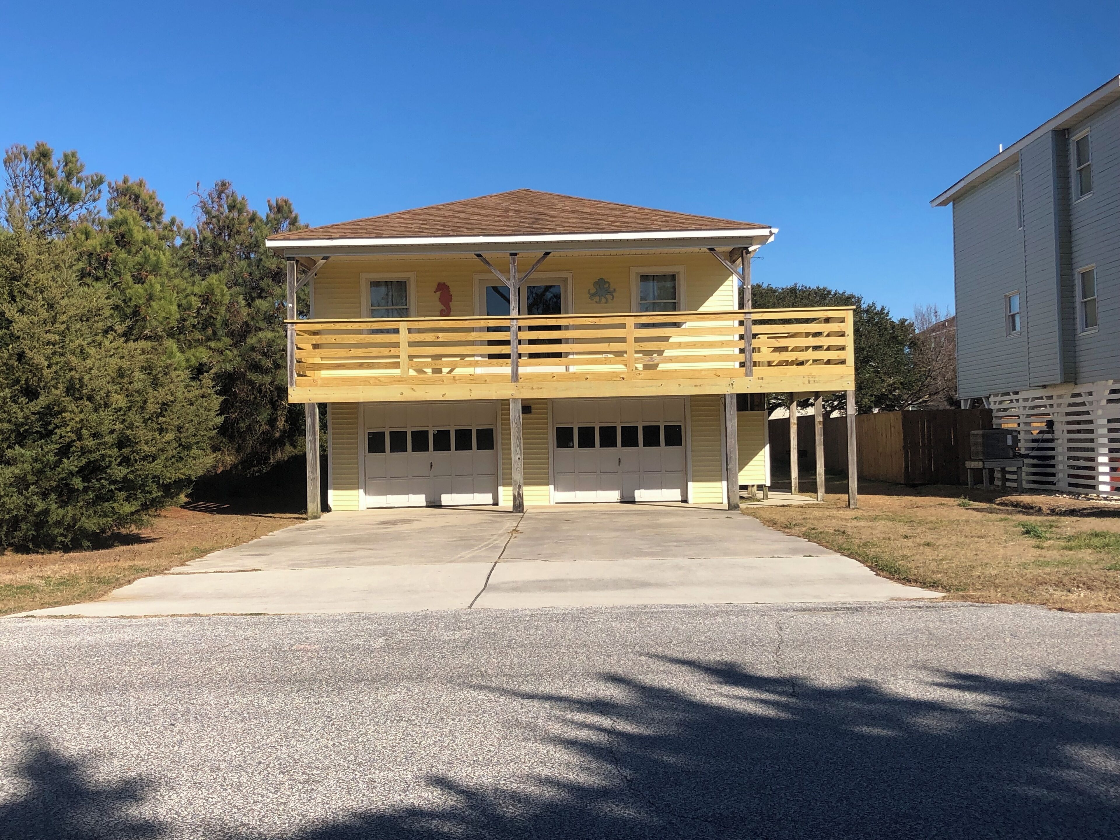 A two-story house with a covered front porch and a garage.
