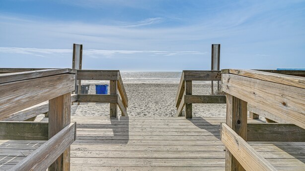 A wooden boardwalk leading to a sandy beach. - Walk to Beach: Condo w/ Balcony in Murrells Inlet! (Murrells Inlet)