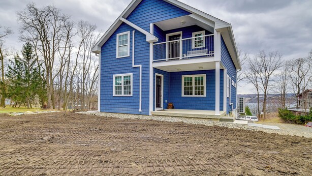 A two-story house with a balcony and a front porch. - Seneca Lake Wine Trail Studio w/ Balcony & Views! (Hector)