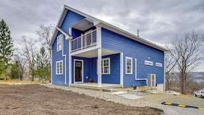 A two-story house with a balcony, a garage, and a driveway. - Seneca Lake Wine Trail Studio w/ Balcony & Views! (Hector)