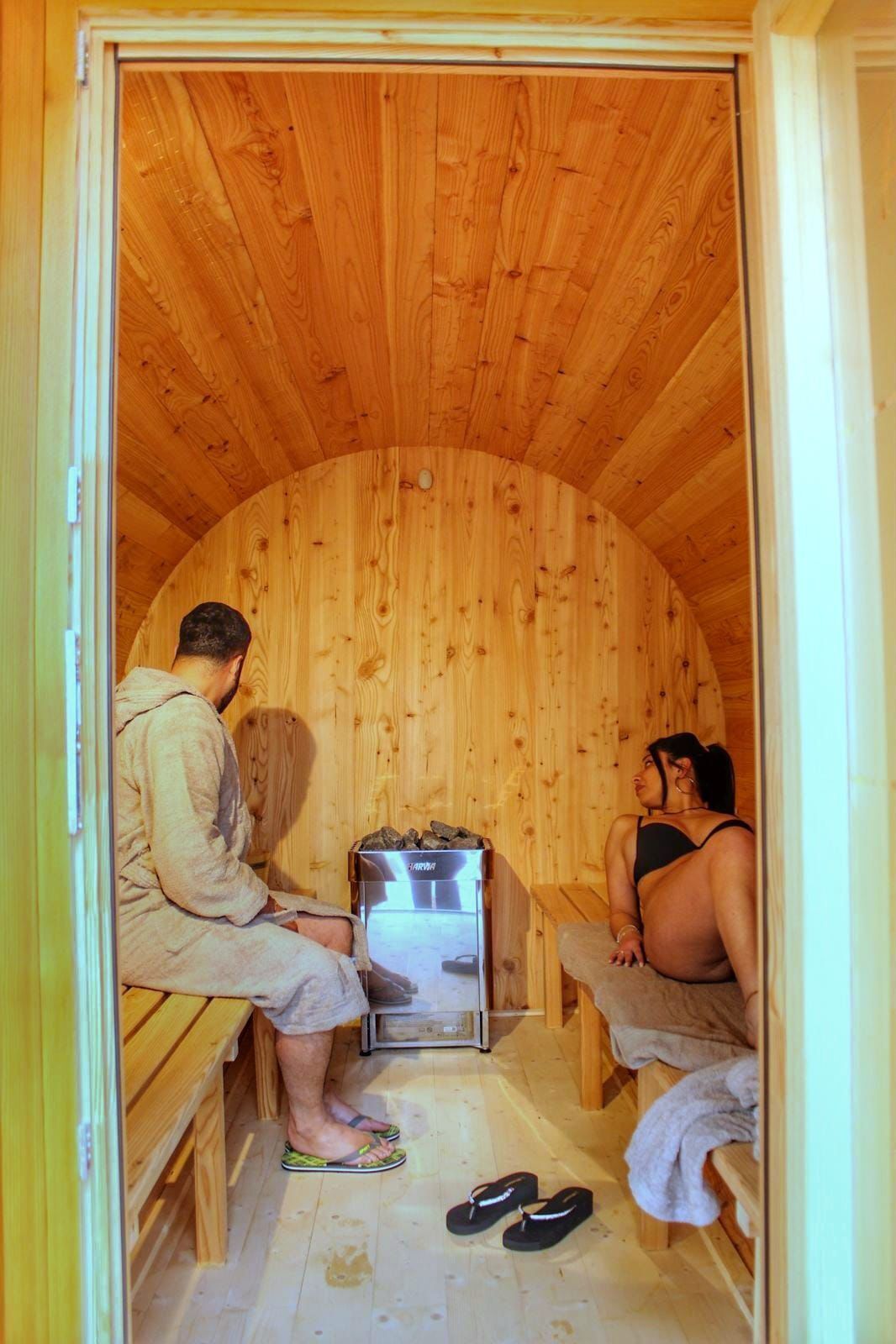 A sauna room with wooden walls and benches.