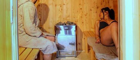 A sauna room with wooden walls and benches.