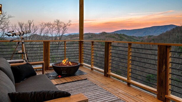 A wooden deck with a fire pit and a telescope, overlooking a mountainous landscape. - Reflections 1 Bedroom Cabin (Sevierville)