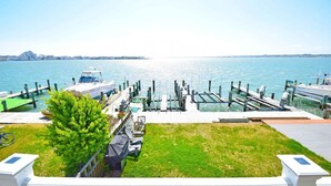 A marina with docked boats, a grassy area, and a clear view of the water. - Village West 1 3 Bedroom Townhouse (Ocean City)