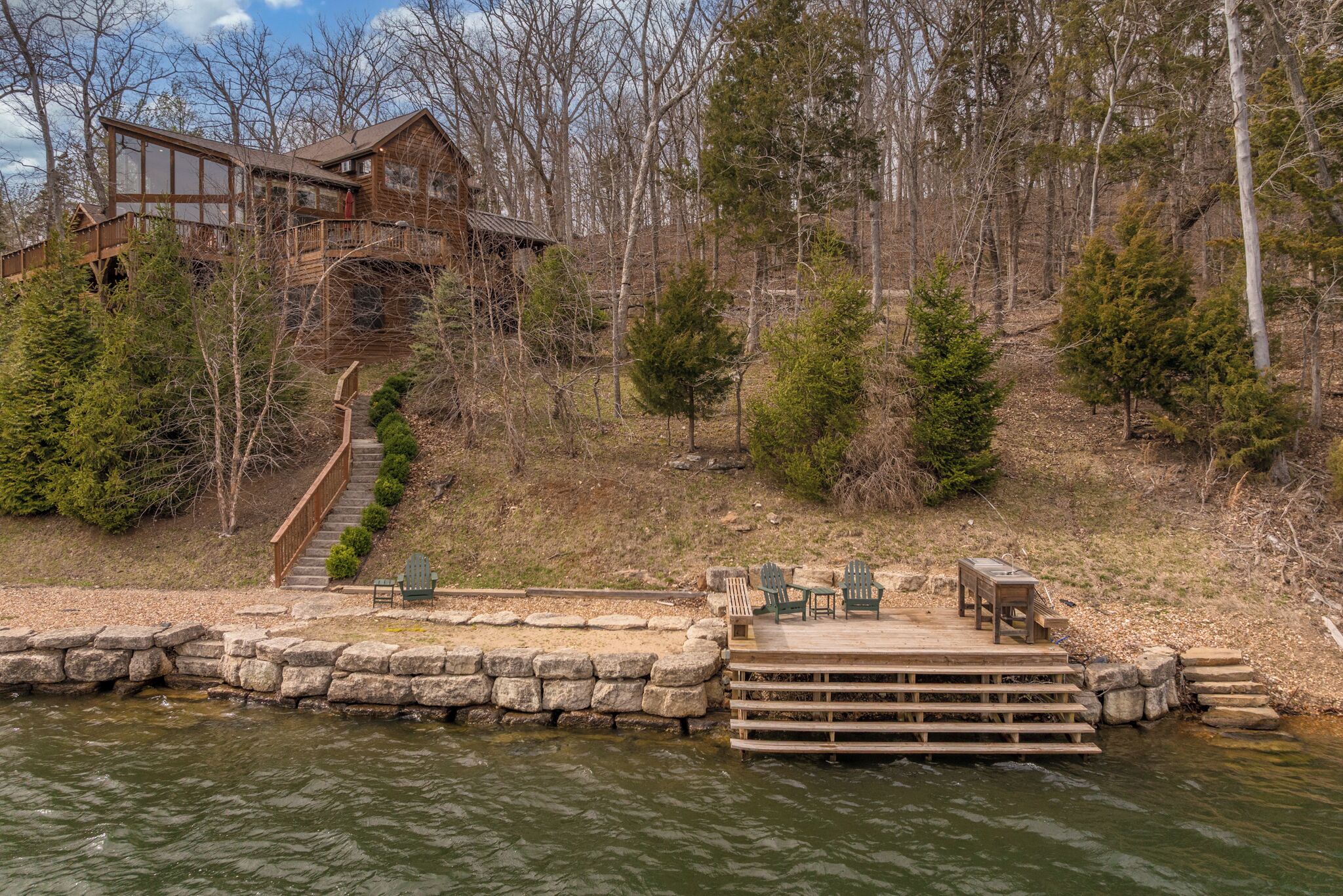 A cabin with a dock and outdoor seating area.
