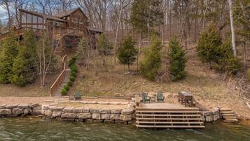 A cabin with a dock and outdoor seating area.