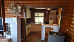 A compact kitchen with wooden cabinets, a sink, and a countertop. - Near Pullmann City - small house in the middle of nature... Vacation for the whole year... (Windorf)