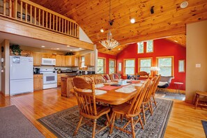 A spacious kitchen with wooden cabinets, a microwave, and a refrigerator.